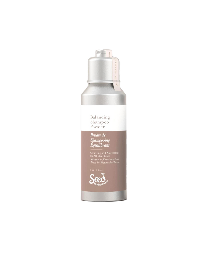 Seed Phytonutrients Balancing Shampoo Powder in a sleek silver bottle with a white and brown label. 