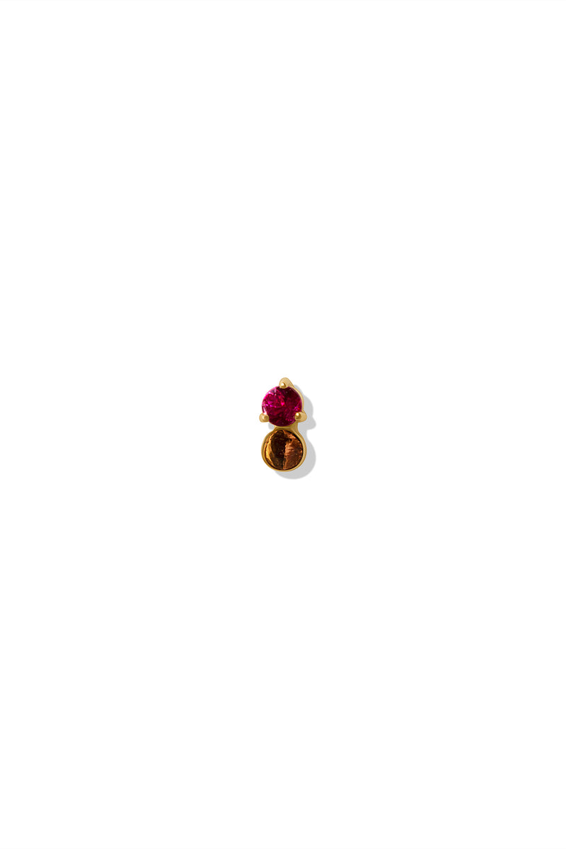 A 14k gold stud earring featuring a round ruby gemstone set in a prong setting at the top, with a small gold disc dangling below. 