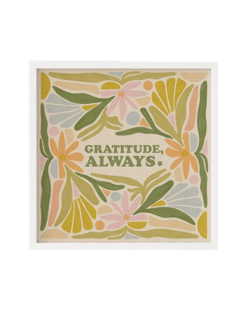 A framed print with the phrase "GRATITUDE, ALWAYS" in green capital letters. Surrounding the text is an abstract floral design in shades of green, pink, yellow, and orange, set against a beige background.