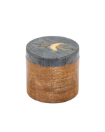 Image of a closed round moon box made of mango wood with a black marble lid featuring a brass moon and rays design. 