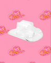 A clear acrylic cowboy hat-shaped bowl displayed against a pink background with a pattern of illustrated cowboy hats in pink and orange. 