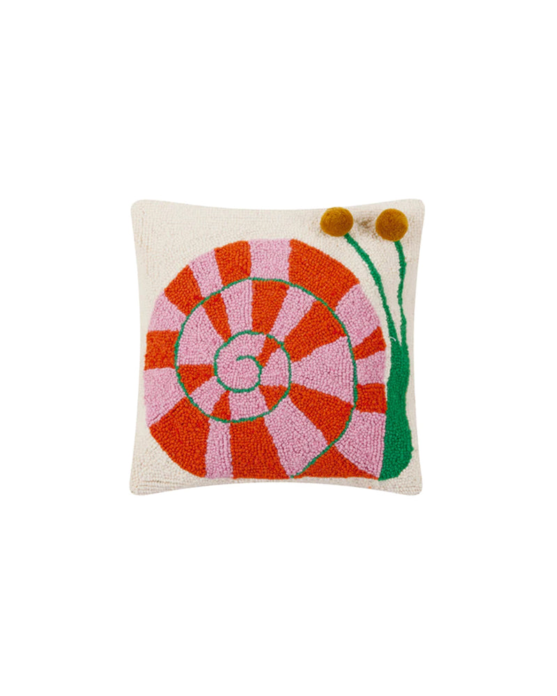 A square accent pillow featuring a vibrant snail design with a pink and red spiral shell, green antennae, and yellow pom-poms for eyes. The background is a neutral cream color, and the pillow is made of 100% wool with a luxurious polyester velvet backing.