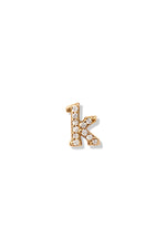 A small 14K yellow gold stud earring in the shape of the letter "k", encrusted with diamonds.