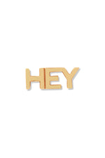 A 14K gold stud earring in the shape of the word "Hey", displayed against a white background. 