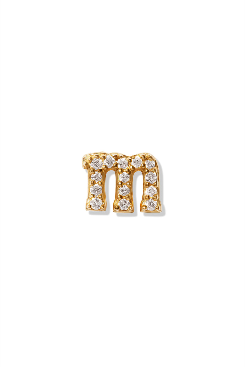 A small 14K yellow gold stud earring in the shape of the letter "m", encrusted with diamonds.