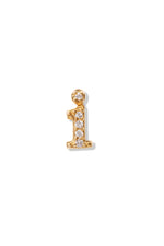 A small 14K yellow gold stud earring in the shape of the letter "i", encrusted with diamonds.