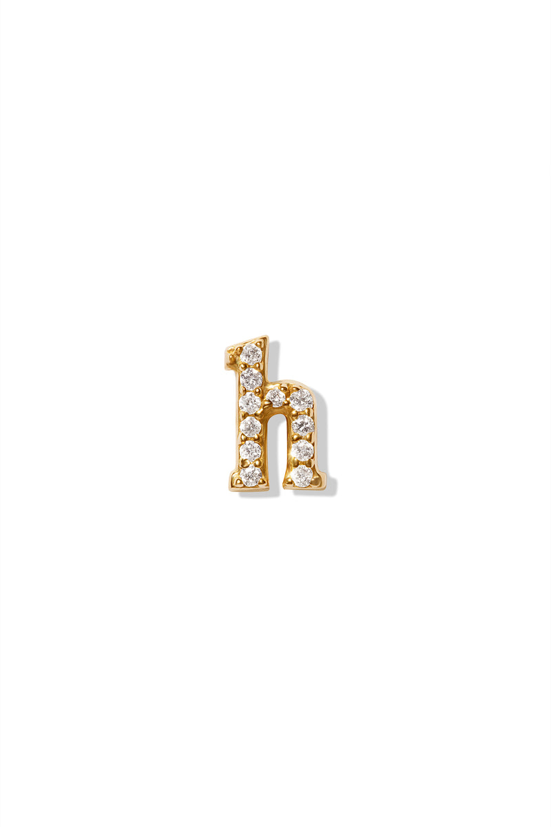 A small 14K yellow gold stud earring in the shape of the letter "h", encrusted with diamonds.