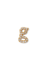 A small 14K yellow gold stud earring in the shape of the letter "g", encrusted with diamonds.